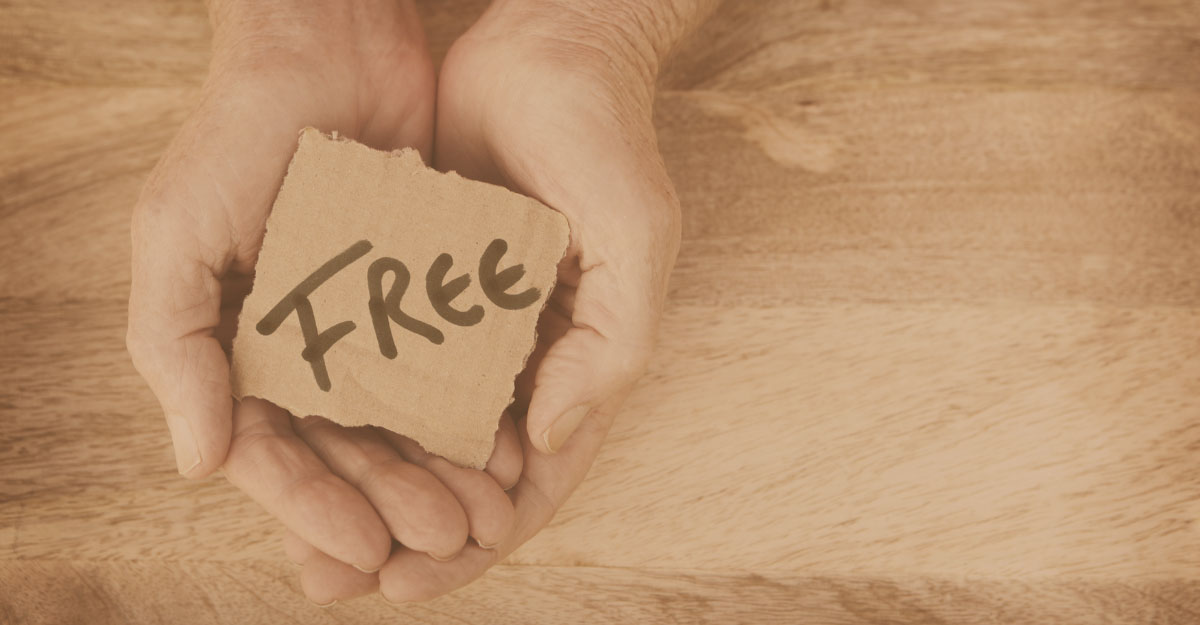 hands holding piece of paper with the word FREE
